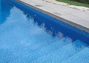 Blue Crystal Clear Swimming Pool with Rock Waterfall, Beautiful Backyard